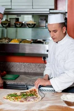 Chef busy in preparing pizza Stock Photos