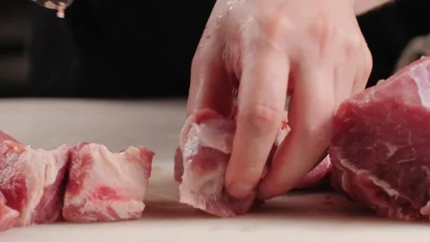 Chef Butcher cutting pork meat with knife on kitchen, cooking Mexican Stock Footage 242530874
