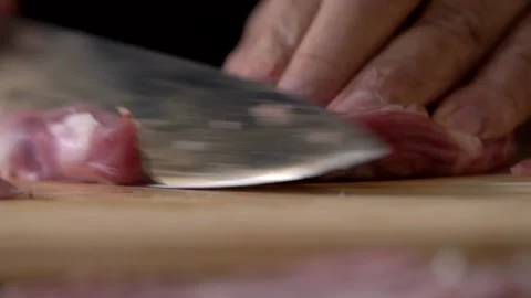 Chef Butcher Cutting Pork Meat with Knife in Kitchen Stock Footage 296522480