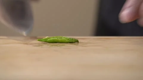 Chef Butcher Hitting Bird Chilli with Knife in Kitchen Stock Footage 296522475