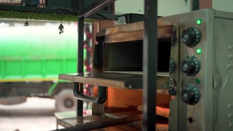 The chef at the cafe pulls a hot, juicy pizza out of the oven. Slow motion video Video stock 231336099