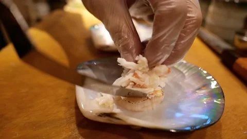 The chef carefully puts the king crab meat in the shell to decorate the dish Stock Footage 171736565