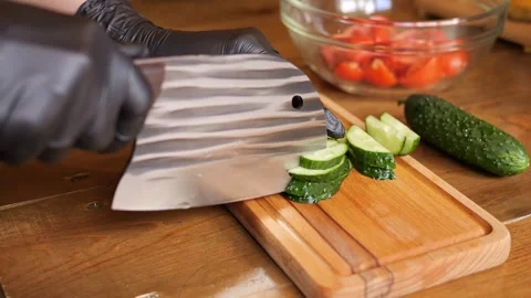 Chef carefully slices a cucumber. Photos capture bright green skin and crunchy Stock Footage 278032453