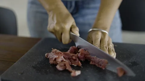 Chef Carefully Slicing Fresh Raw Beef On A Cutting Board Stock Footage 338052462