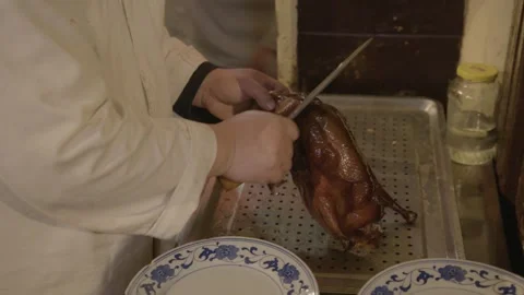 Chef Carving Roasted Poultry in Beijing Restaurant Kitchen for Serving Stock Footage 345772890