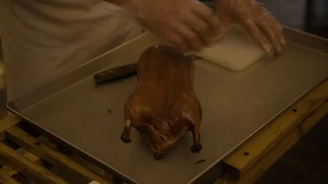 Chef Carving Roasted Poultry in Beijing Restaurant Kitchen, Close Up Preparation Stock Footage 345784699