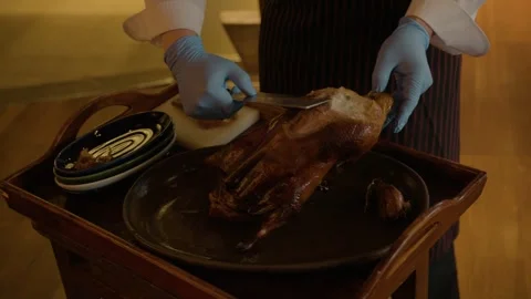 Chef Carving Roasted Poultry at Restaurant Table in Beijing, China for Serving Stock Footage 345781656