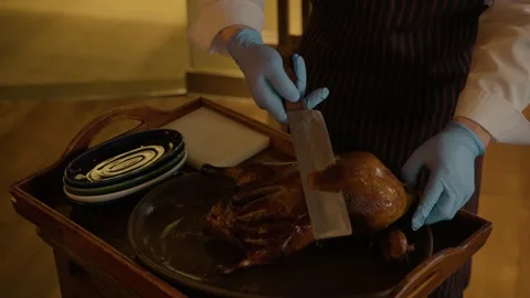 Chef Carving Roasted Poultry Tableside in Beijing Restaurant for Dining Service Stock Footage 345781715