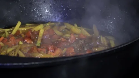 Chef in a cauldron prepares plov Stock Footage 107119946