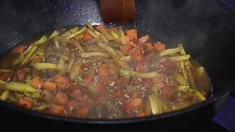 Chef in a cauldron prepares plov Stock Footage 107120002