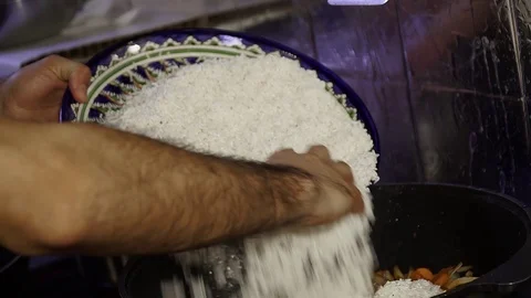 Chef in a cauldron prepares plov Stock Footage 107120029