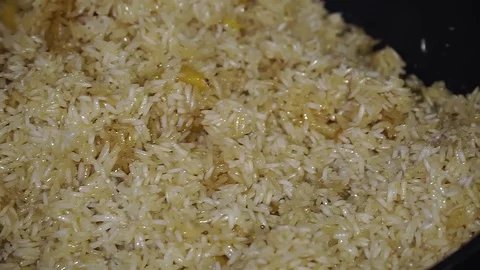 Chef in a cauldron prepares plov Stock Footage 107120104