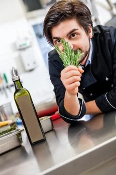 Chef checking the freshness of a bunch of herbs Stock Photos