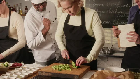 Chef Checking Participants of Cooking Master Class Chopping Vegetables Stock Footage 332572482