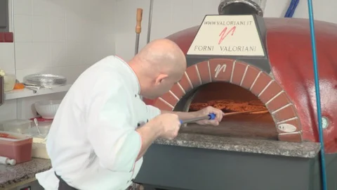 Chef checking pizzas to take them out of the oven  Stock Footage 86907061