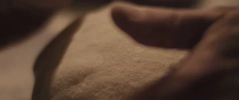 Chef checking the shape of the traditional pizza dough with his hands. Close  Stock Footage 146923822