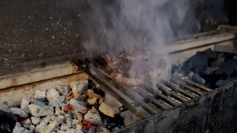 Chef checks if a piece of meat is ready on the grill Stock-Footage 80043329