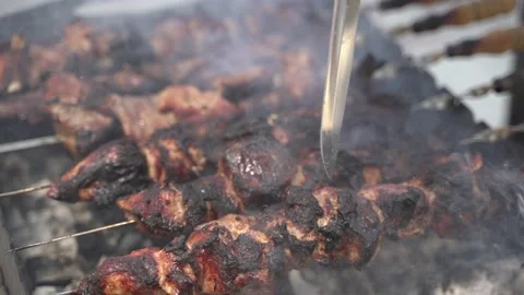 The chef checks the roasted meat before serving 4K Stock Footage 128795092
