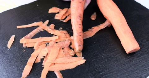 Chef chopped carrot on a black table 스톡 동영상 115657973