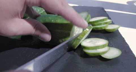 Chef chopped cucumber on a black table Stock Footage 116014935