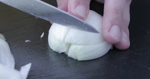 Chef chopped onion on a black table Stock Footage 115657181