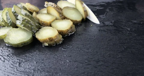 Chef chopped pickled cucumber on a black table Stock Footage 115659946