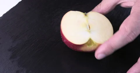 Chef chopped red apple on a black table Stock Footage 115656694