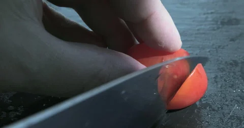 Chef chopped tomato on a black table Stock Footage 115757252