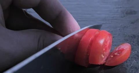 Chef chopped tomato on a black table Stock Footage 116015139