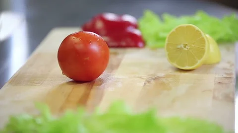 Chef is chopping and slicing fresh tomato Stock Footage