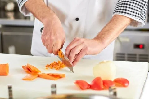 Chef chopping carrot. Stock Photos