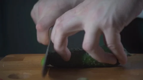 Chef chopping cucumber on a cutting board in a restaurant. Prepare food. Stock-Footage 124756636