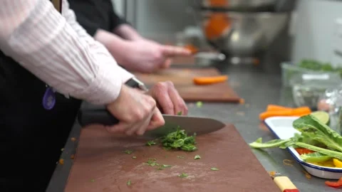 Chef Chopping Fresh Vegetables on Cutting Board in Commercial Kitchen Stock-Footage 321367445