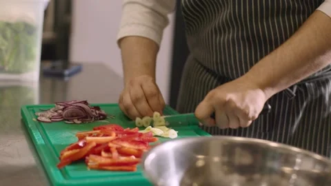 A chef is chopping garlic in a restaurant kitchen. Stock-Footage 277131571