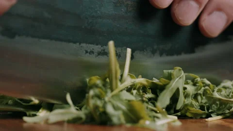 Chef Chopping Green Rocket With A Sharp Knife Video stock 134422669