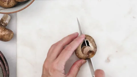 Chef chopping mushrooms, close up view from above Stock Footage 138449643