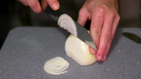 Chef chopping onion with a knife on the cutting board, macro close up of cutting Stock Footage 307486060