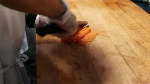 The chef is chopping a piece of salmon into small pieces Stock Footage 172050230