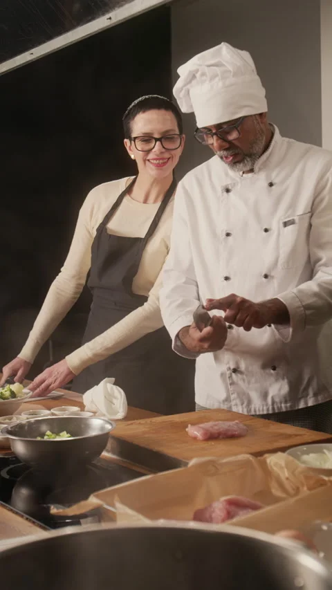Chef Chopping Raw Chicken Brest at Cooking Master Class in Restaurant Stock Footage 332575519