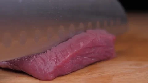 Chef chopping raw meat with knife on cutting board Stock Footage 150457857
