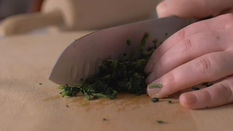Chef Chopping Up Raw Spinach Leaves slow motion Stock Footage 103859636