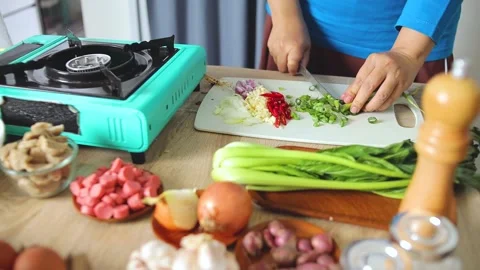 Chef chopping spring onions during food preparation in kitchen Stock Footage 341487433