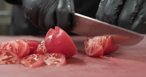 Chef chopping vegetables tomatoes on a cutting board. Male chef preparing fresh Stock Footage 289198955