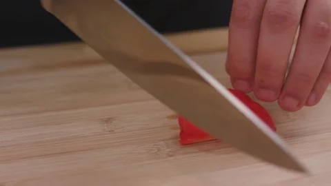 Chef chops and minces vegetables pepper a before cooking Stock Footage 82487411