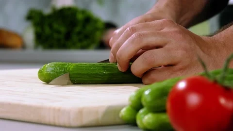 Chef chops the cucumber Stock Footage 221850191