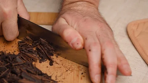 Chef chops mall pieces chocolate by knife, cooking with chocolate, sweet pastry 库存影片 126117925