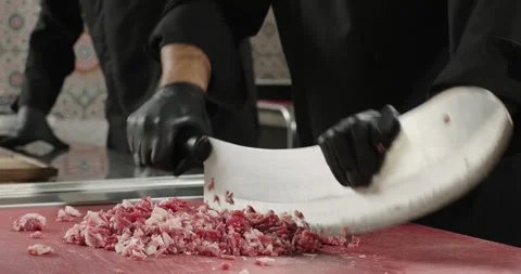 Chef chops meat using big knife or axe. Handmade ground meat. Middle Eastern Stock Footage 274674922