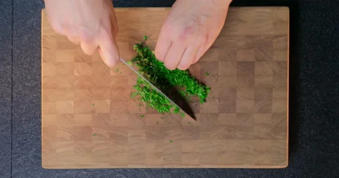 A chef chops parsley on cut board. Stock Footage 231214178
