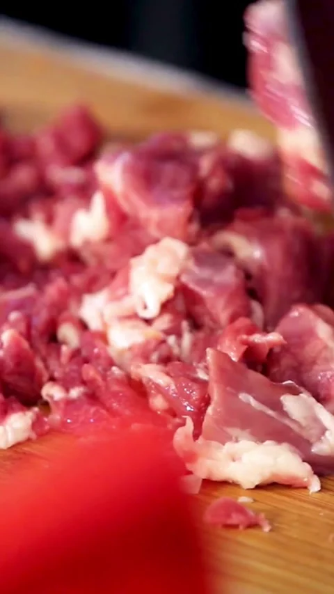 Chef chops raw beef into small pieces with knife Video stock 334169723