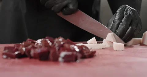 Chef chops sheet tail fat on a cutting board to prepare liver kebab. Oriental Stock Footage 274180161